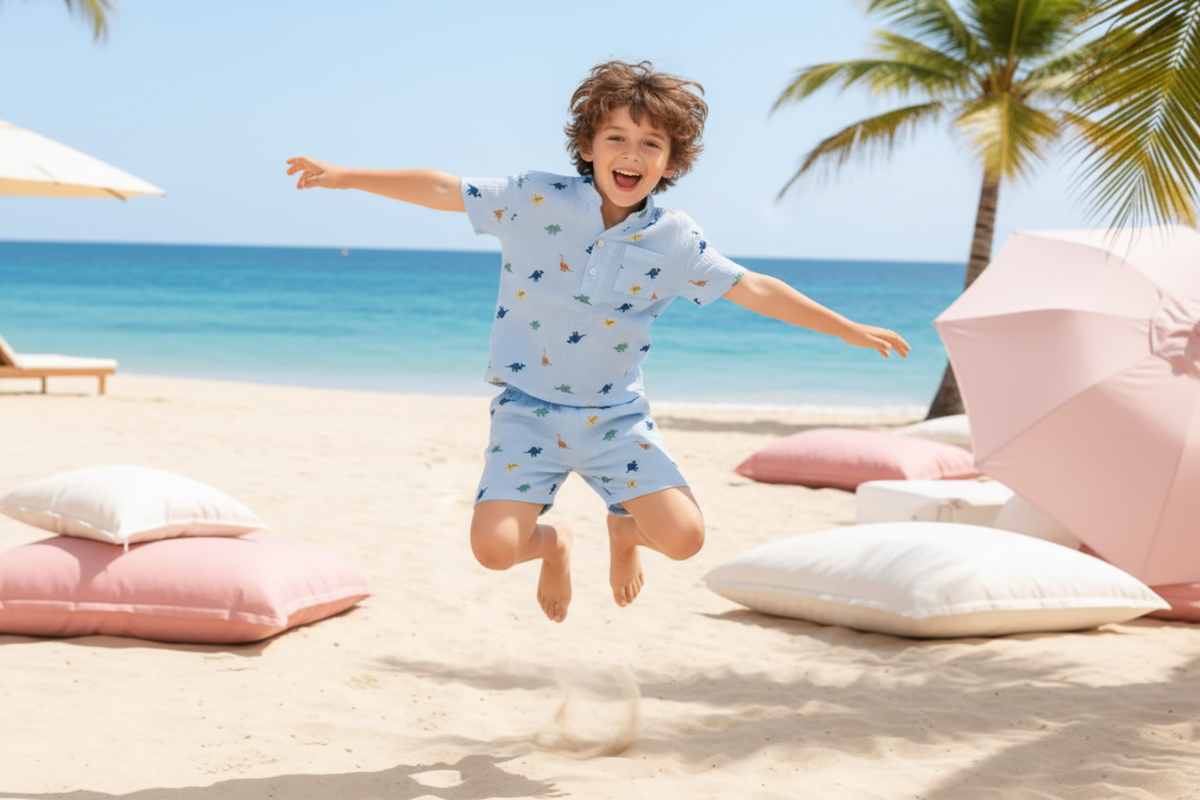 A young boy, around 6-8 years old, wearing a colorful, lightweight Lunero two-piece outfit, running happily outdoors on a sun